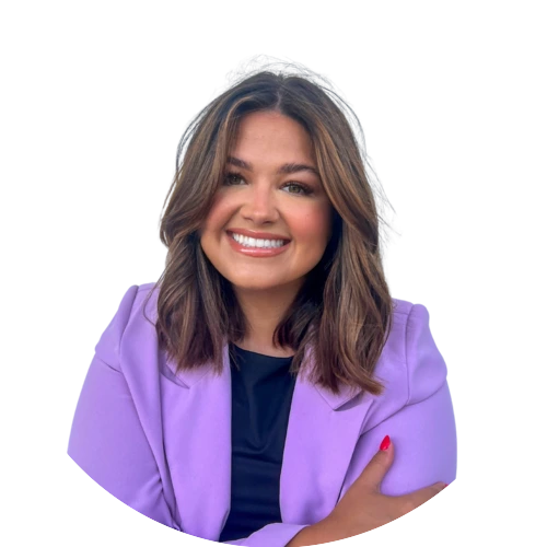 Professional headshot of a smiling woman with shoulder-length brown hair, wearing a lavender blazer over a black top.